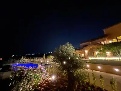a view of a building with lights at night at sofia Farm in Al Salt