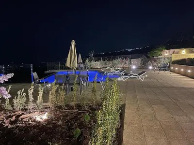 a table and chairs in a courtyard at night at sofia Farm in Al Salt