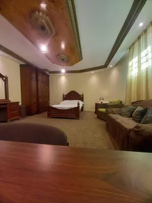 a large living room with a bed and a couch at Luxury furnished apartment for rent - شقة فاخرة مفروشة للإيجار in Amman