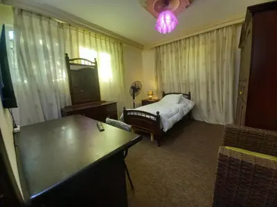 a hotel room with a bed and a table at Luxury furnished apartment for rent - شقة فاخرة مفروشة للإيجار in Amman