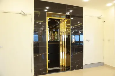 a large glass elevator in a building with a mirror at Petra Brothers in Petra