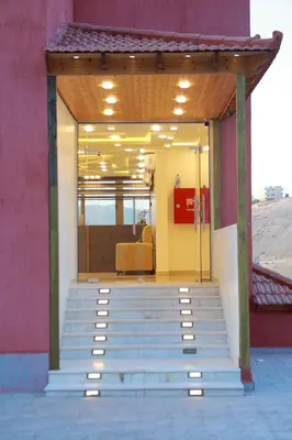 a entrance to a building with stairs and a chair at Petra Brothers in Petra