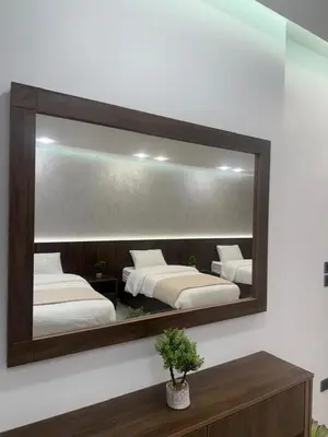 a mirror on a wall with two beds at Taj Villa 2 - entire Villa in Deadsea front beach in Sowayma