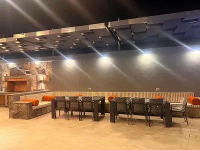 a dining room with a table and chairs and lights at Taj Villa 2 - entire Villa in Deadsea front beach in Sowayma