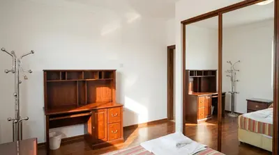 a bedroom with a desk and a mirror at Cozy & Spacious 3 En-Suite Bedroom Apartment in Amman