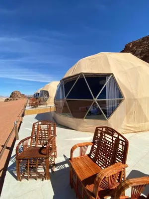 a group of chairs and tents in the desert at Desert yanal wadi rum in Disah