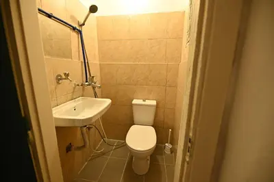 a small bathroom with a toilet and a sink at AL Majd hostel in Amman
