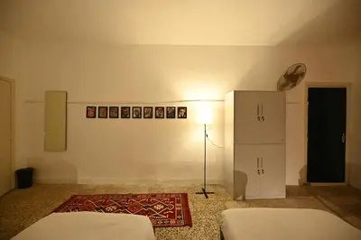 a room with two beds and a lamp in it at AL Majd hostel in Amman