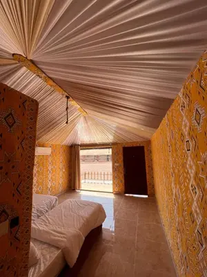 a large tent with a bed in a room at Isabella Luxury Wadi Rum in Wadi Rum