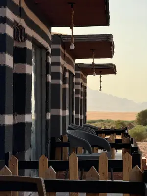 a group of chairs sitting on the side of a building at Isabella Luxury Wadi Rum in Wadi Rum