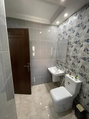 a bathroom with a toilet and a sink at Apartment in Jabal Amman, very beautiful, new in Amman