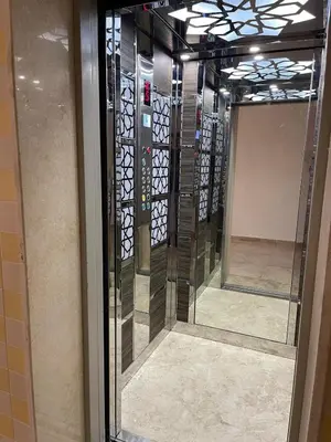 a glass door with a mirror in a room at Apartment in Jabal Amman, very beautiful, new in Amman