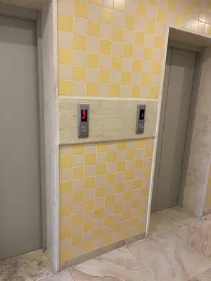 a bathroom with yellow tiles on a wall with two doors at Apartment in Jabal Amman, very beautiful, new in Amman