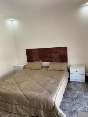 a bedroom with a large bed and two night stands at Apartment in Jabal Amman, very beautiful, new in Amman
