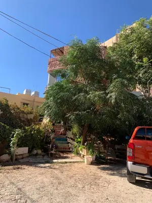 a red van parked in front of a building at Monastery in Wadi Musa