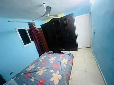 a room with a bed and a ceiling fan at Sky apartment in Amman
