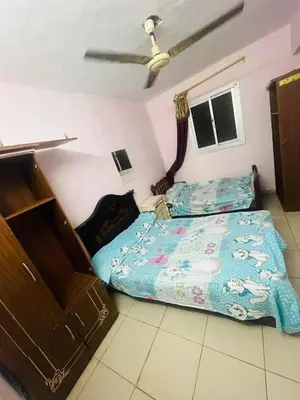 a bedroom with a bed and a bedspread on the floor at Sky apartment in Amman