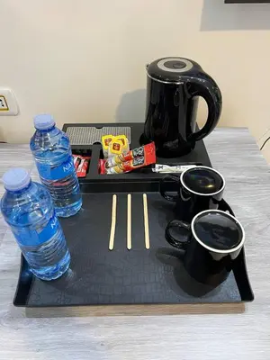 a tray with a tea kettle and two bottles of water at The charming view in Wadi Musa