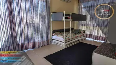 a small bed in a room with a curtain at Private Chalet in Dabouq , Night-Lit in Amman