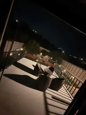 a shadow of a person on a balcony at night at Private Chalet in Dabouq , Night-Lit in Amman