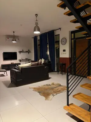 a living room with a couch and a table at Private Chalet in Dabouq , Night-Lit in Amman