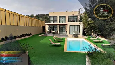 a house with a yard with a swimming pool at Private Chalet in Dabouq , Night-Lit in Amman