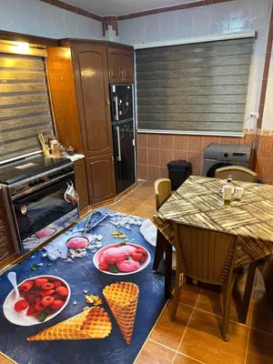 a kitchen with a table with plates of food on it at شقة مفروشة واسعة وهادئة in Umm Juraysāt