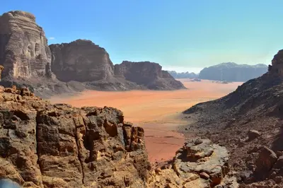 a view of a desert with rocks and mountains at Moon light in Disah