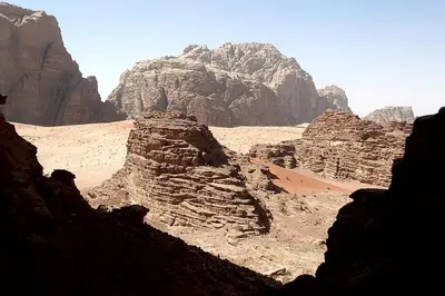 a view of a desert with mountains and rocks at Moon light in Disah