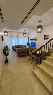 a living room with a couch and a table at Al-Raha Luxury apartment in Aqaba