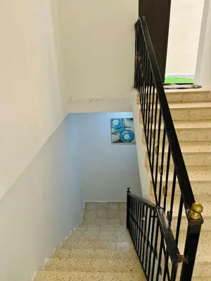 a staircase in a house with a blue floor at شقة واسعة وهادئة in Umm Juraysāt