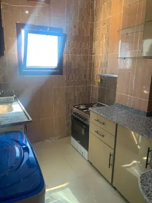 a small kitchen with a stove and a window at Jorh BB in Amman