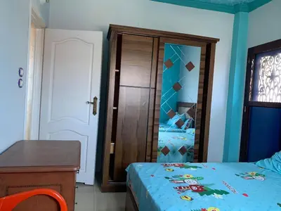 a bedroom with a bed and a desk and a mirror at Jorh BB in Amman