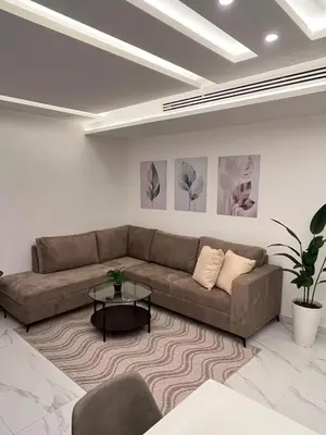 a living room with a couch and a table at Luxurious 2 bedroom furnished apartment in Abdoun in Amman