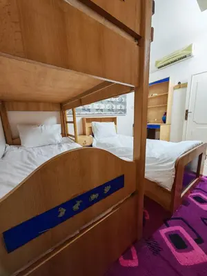 two bunk beds in a room with purple carpet at Luxury Apartments in Aqaba
