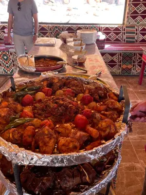a table with a bunch of food on a table at Red Dunes Wadi Rum Camp in Wadi Rum