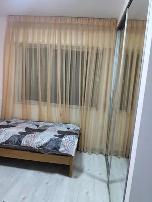 a bed in front of a window with curtains at عمان in Amman