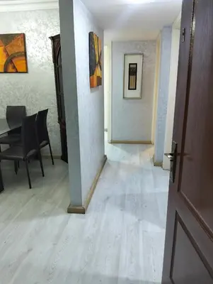 a hallway with a table and chairs and a door at عمان in Amman