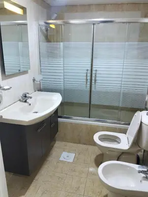 a bathroom with a sink and a toilet and a shower at عمان in Amman