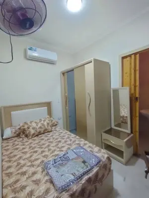 a bedroom with a bed and a dresser and a mirror at Sama rjan in Irbid