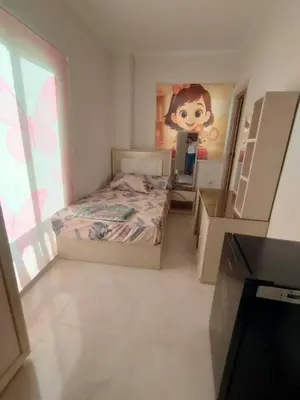 a bedroom with a bed and a painting on the wall at Sama rjan in Irbid