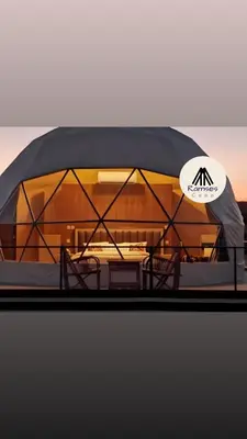 a dome tent with chairs and a table at Ramses luxury rum camp in Wadi Rum