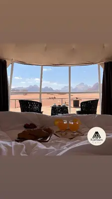 a white bed with a view of the desert at Ramses luxury rum camp in Wadi Rum