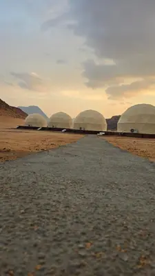 a group of domes in the desert with a road at Fahd Camp Wadi Rum in Wadi Rum