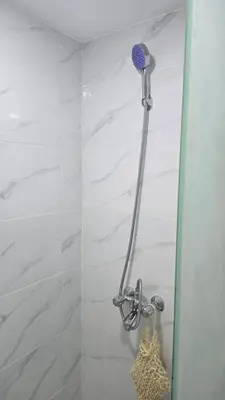 a shower with a shower head in a bathroom at Fahd Camp Wadi Rum in Wadi Rum