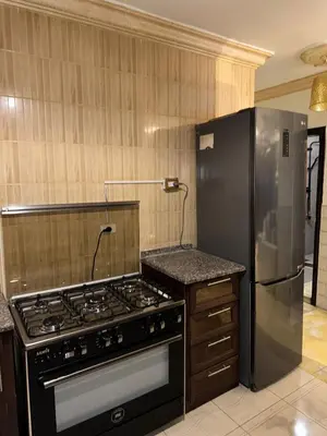 a kitchen with a stove and a refrigerator at Super deluxe apartment in Irbid