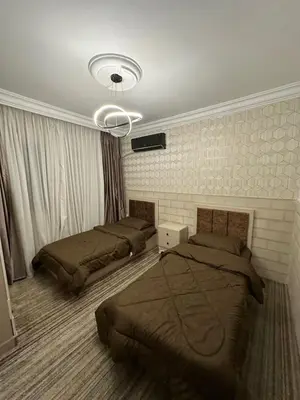 a bedroom with two beds and a ceiling at Super deluxe apartment in Irbid