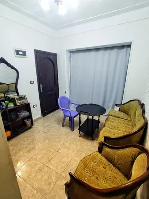 a living room with a couch and a table at Hi motel in Al ‘Iş