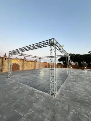 a large metal structure in a parking lot at مزرعة وشاليه ادم
