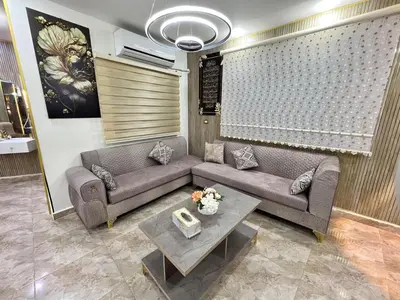 a living room with a couch and a table at مزرعة وشاليه ادم